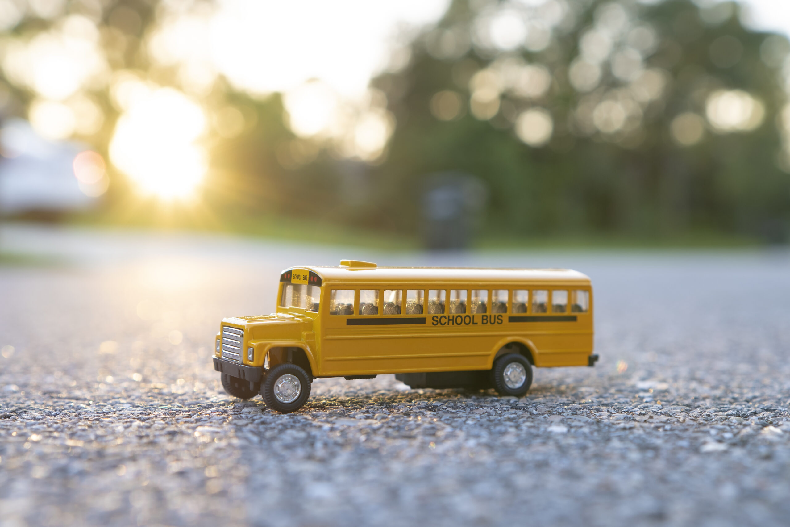 Toy american yellow school bus as symbol of education in the USA